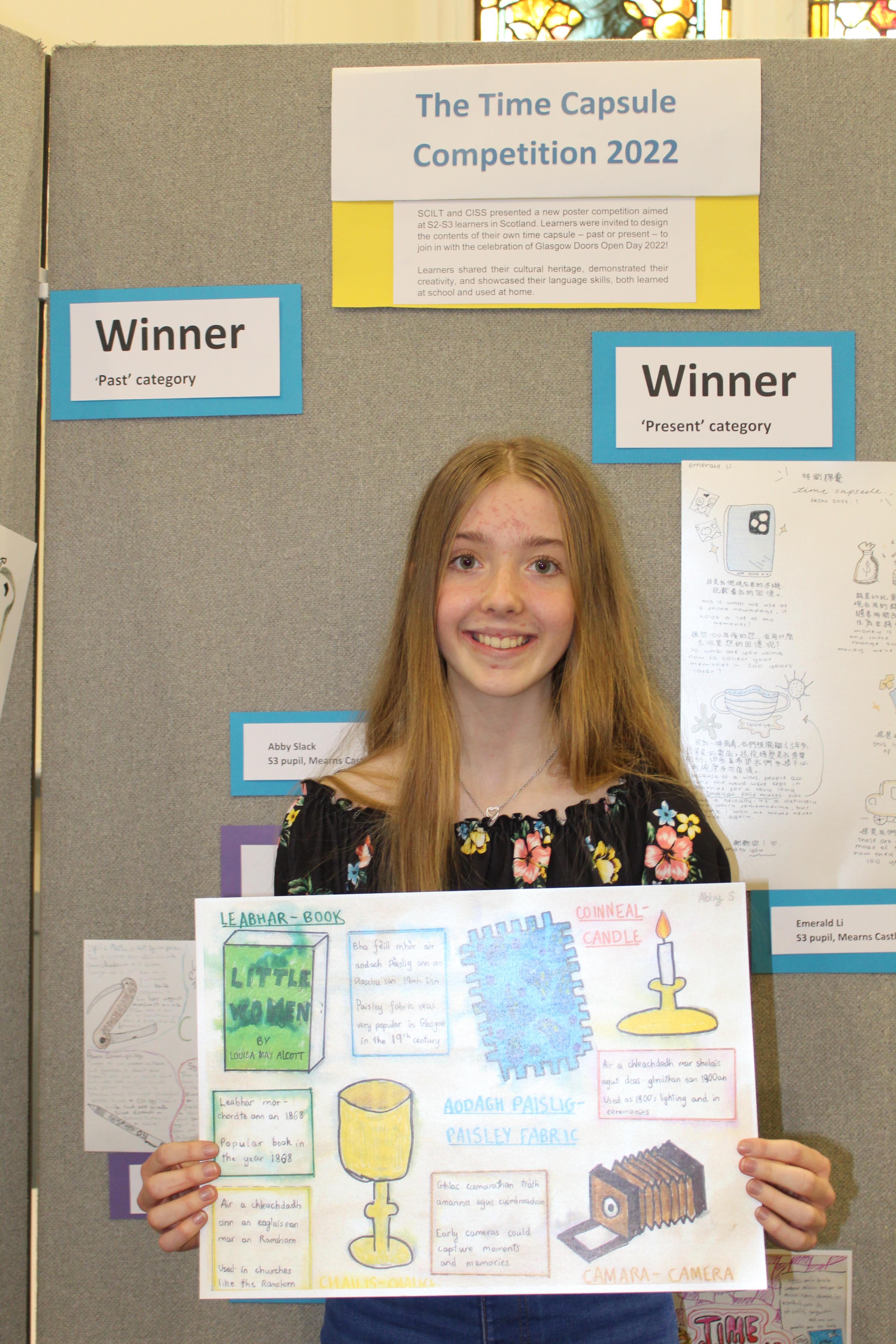 photo of Abby Slack holding her winning poster photo of Abby Slack holding her winning poster